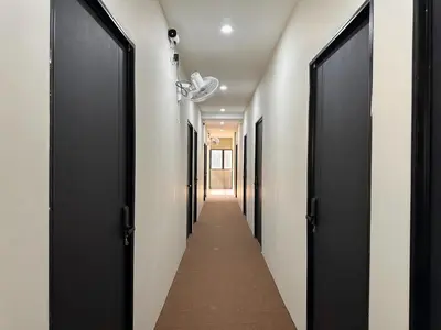 a hallway with black doors and a long corridor at Li's Inn in George Town