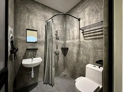a bathroom with a shower and a toilet and a sink at Li's Inn in George Town