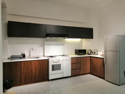 a kitchen with a white stove and a refrigerator at City Tropical Home II in George Town