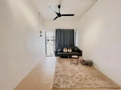 a living room with a black couch and a ceiling fan at Home10perwira#6pax#netflix#simpangampat#neariconicpoint in Simpang Ampat