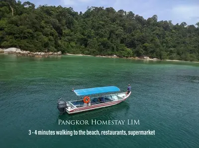 a man on a boat in the water at Pangkor Homestay in Pangkor