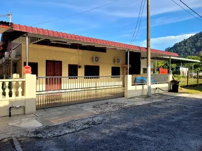 a building with a red roof on a street at Pangkor Homestay in Pangkor