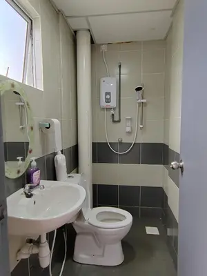 a bathroom with a shower and a toilet and a sink at MujiStyle Brinchang Emerald Apartment Cameron 8guests 3bedrooms3bathroom in Brinchang