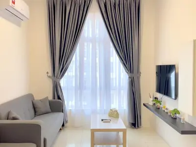 a living room with a couch and a large window at Anderson Ipoh Blissful Homestay in Ipoh