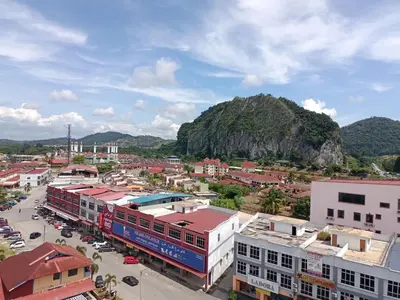 an aerial view of a city with buildings and a mountain at SS APARTMENT MUTIARa in Gua Musang