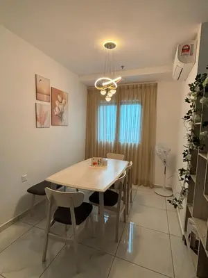 a dining room with a wooden table and chairs at Cozy House in Batu Kawan