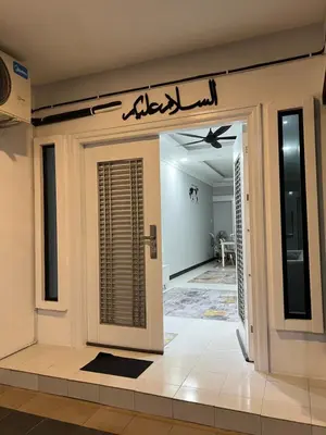a front door of a house with a sign above it at yasmins homestay in Sitiawan