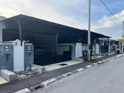 a building with a gate and a parking lot at yasmins homestay in Sitiawan