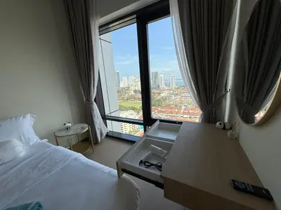 a hotel room with a bed and a large window at Macalister Suite - 2 Bedrooms in George Town