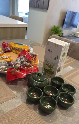 a table with green donuts and a box of candy at Macalister Suite - 2 Bedrooms in George Town