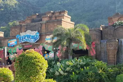 a disney theme park with a palm tree in front of a building at COZY Home Terrace - 1km to Water Theme Park Tambun Ipoh in Ipoh