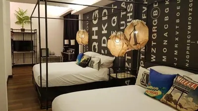 a bedroom with two beds and a wall covered inogie at M Boutique Hotel Station 18 - Ipoh in Ipoh