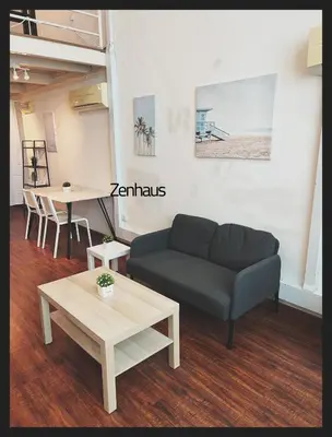 a living room with a couch and a table at THE CEO LOFT by Zenhaus in Bayan Lepas