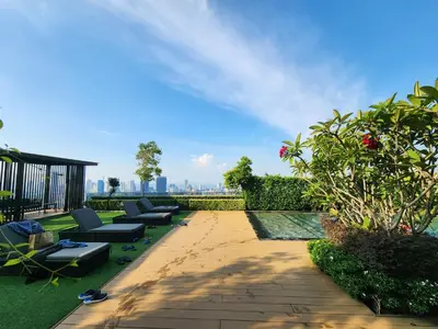 a patio with chaise lounges and plants on a building at Georgetown Modern CosyStay in George Town