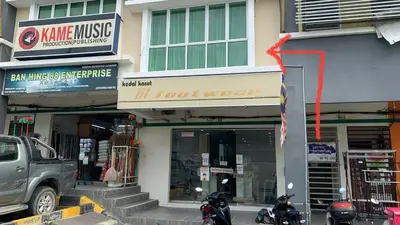 a building with motorcycles parked in front of a store at Mimi 1 Bedroom Studio House Homestay in Gerik