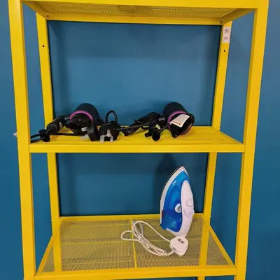 a yellow shelf with a phone and other items on it at TG103a Pet Friendly 15pax, near beach side in Tanjung Bungah