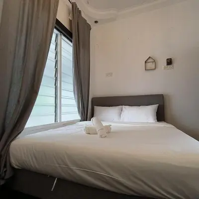 a bed in a room with a large window at TG103a Pet Friendly 15pax, near beach side in Tanjung Bungah