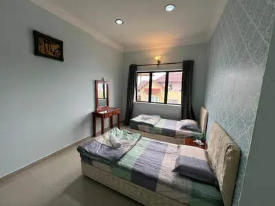 a bedroom with two beds and a window at Cottage Hill -Cameron Highlands in Cameron Highlands
