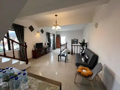 a living room with a teddy bear sitting on a chair at Cottage Hill -Cameron Highlands in Cameron Highlands