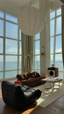 a living room with a leather couch in front of windows at Haus in George Town