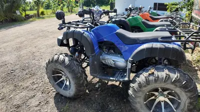 a group of four atvs parked on a dirt road at Love UU Garden - Paddy View Stay with Bicycle Ride in Balik Pulau