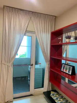 a room with a sliding glass door to a balcony at Straits Garden Suites in Jelutong