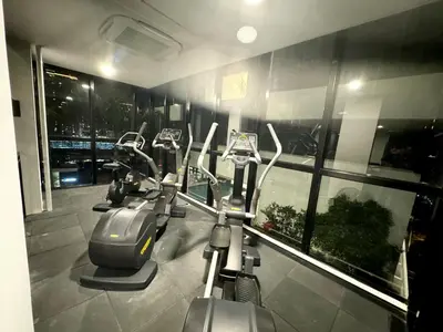 a row of cardio exercise bikes in a gym at Big screen cinema tv, 5 queen bed Luxury apt 2cp in Jelutong