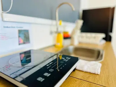 a tablet computer sitting on top of a kitchen counter at Big screen cinema tv, 5 queen bed Luxury apt 2cp in Jelutong