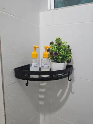 a shelf with three bottles and a plant on a wall at Mikayla Homestay in Ipoh