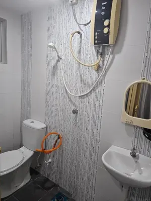 a bathroom with a toilet and a sink at Mikayla Homestay in Ipoh