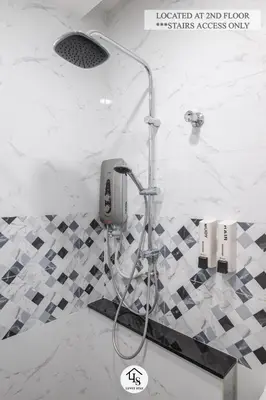 a shower in a bathroom with black and white tiles at IPOH CAIP TownHouse UpperUnit 4R3B Ipoh Tambun 10Pax by Luvit Stay in Ipoh