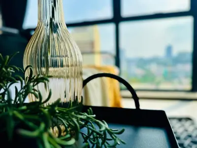 a glass vase sitting on top of a table with a plant at CoZY FAMILY STAY GEORGETOWN 3BR -10PAX URBAN in Jelutong