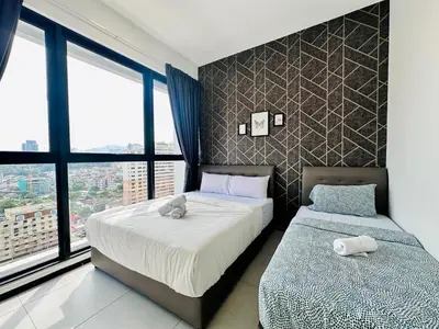 a bedroom with two beds and a large window at a29 seaview luxury 3BR-10PAX URBAN NETFLIX in Jelutong