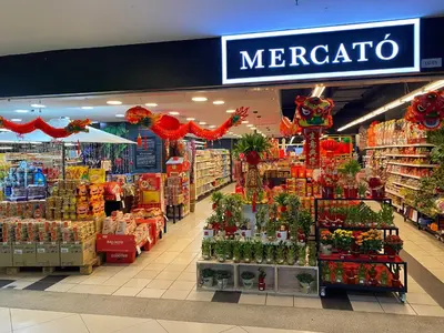 a supermarket aisle with a merecota sign and flowers at 118 Island Plaza by ZenZone88 in Tanjong Tokong