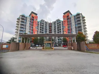 an empty parking lot in front of tall buildings at Bright Apartment in Klebang in Ipoh