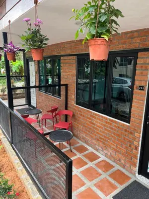 a balcony with chairs and tables and potted plants at Big Dreams Hotel in Tanah Rata