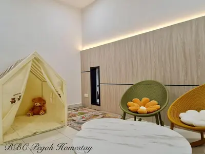 a room with a bed and two chairs and a play tent at BBC Pegoh in Ipoh