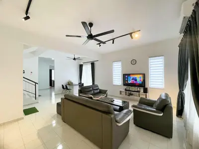 a living room with couches and a flat screen tv at Cozy living 2 Storey Haus 4Room10Pax-Near Icon City in Bukit Mertajam