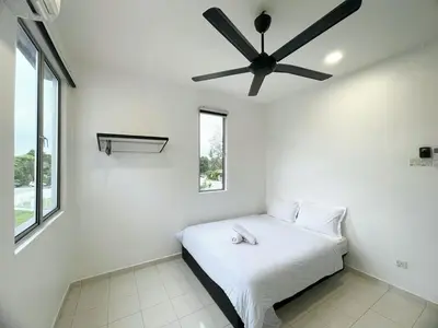 a bedroom with a bed with a ceiling fan at Cozy living 2 Storey Haus 4Room10Pax-Near Icon City in Bukit Mertajam
