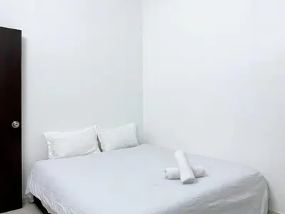 a white bed with a stuffed animal on top of it at Cozy living 2 Storey Haus 4Room10Pax-Near Icon City in Bukit Mertajam