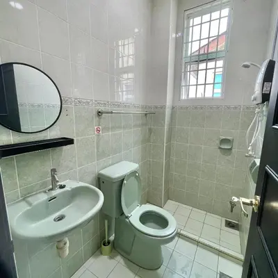 a bathroom with a toilet and a sink and a mirror at Cozyhaus Ipoh in Ipoh