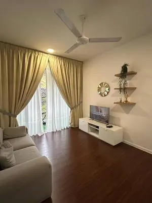 a living room with a couch and a flat screen tv at Ella Residence Homestay in Brinchang