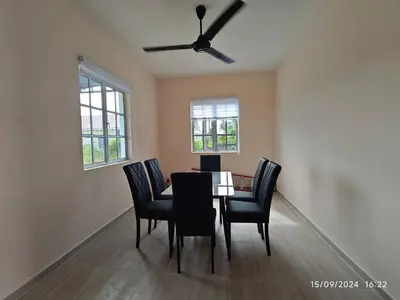 a dining room table with chairs and a ceiling fan at Syakeel Homestay Bandar Bharu, Parit Buntar & Nibong Tebal in Bandar Baharu