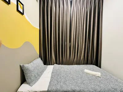 a small bedroom with a bed with a curtain at Home Away From Home in Penang in Jelutong