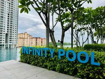 a sign for mercy pool in front of buildings at Home Away From Home in Penang in Jelutong