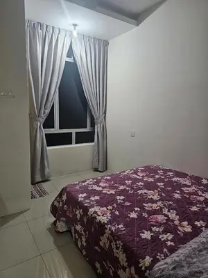 a bedroom with a purple bed and a window at Mikayla homestay in Ipoh