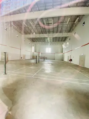 an empty gym with a tennis court in a building at Aiqa homestay in Ipoh