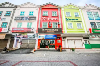 a row of buildings on a city street at De Hotel in Teluk Intan