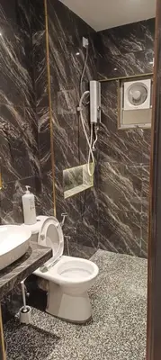 a bathroom with a toilet and a sink at Adik Aisyah goldblack homestay cameron highlands in Tanah Rata
