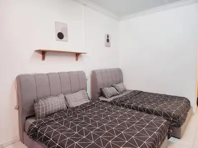 a bed and a couch in a room at 5 min to ipoh town pasir puteh 5br 22pax in Ipoh